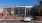 The exterior of the Little Tart Bakery and Cafe near our apartments in Atlanta, featuring parking spots and a brick facade.