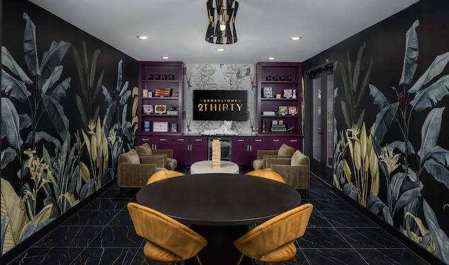 Resident lounge at Broadstone 2Thirty apartments in Atlanta, GA, featuring tables with chairs and floral wallpaper. Resident lounge at Broadstone 2Thirty apartments in Atlanta, GA, featuring tables with chairs and floral wallpaper.
