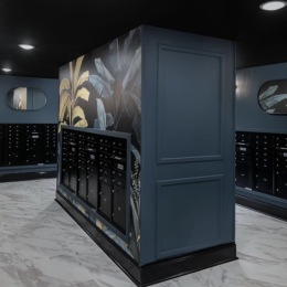 Resident lounge at Broadstone 2Thirty apartments in Atlanta, GA, featuring tables with chairs and floral wallpaper.