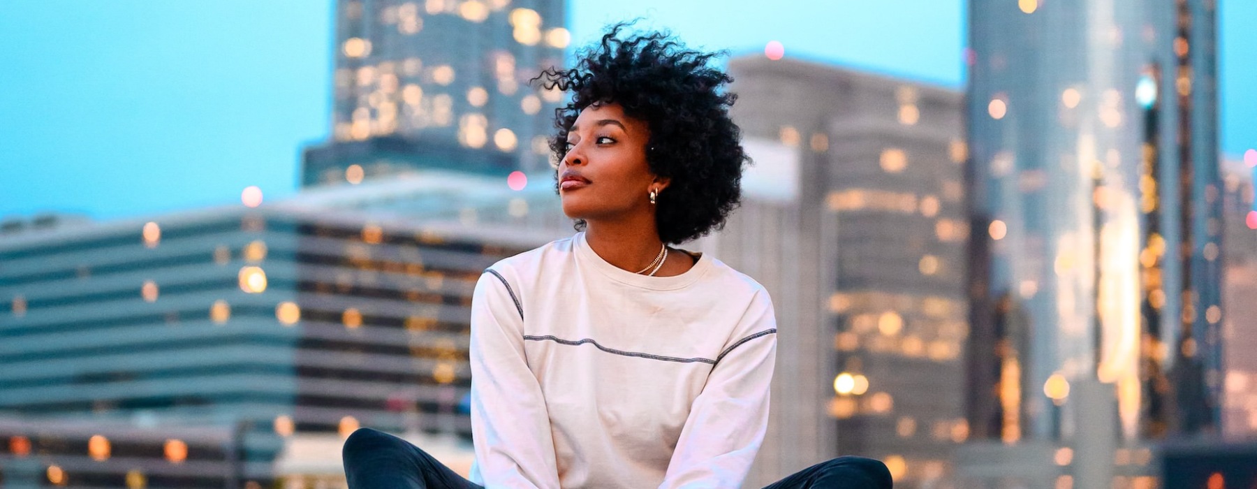 lifestyle image of a woman in front of a city skyline